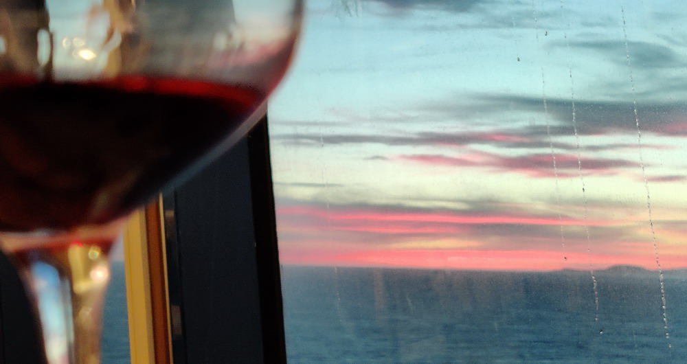 Enjoying a glass of wine, watching the sunset on a cruise